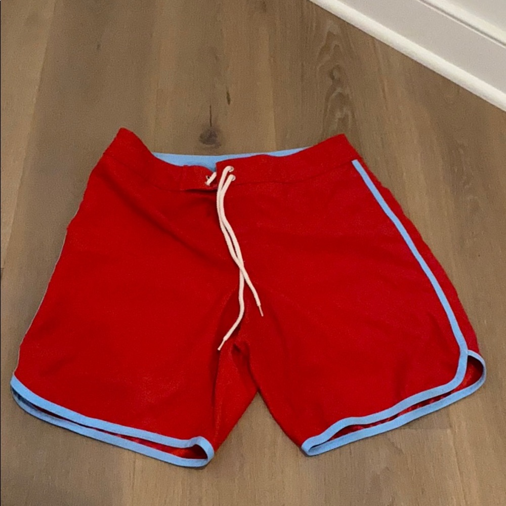 Red swim trunks with blue lining and pocket detail